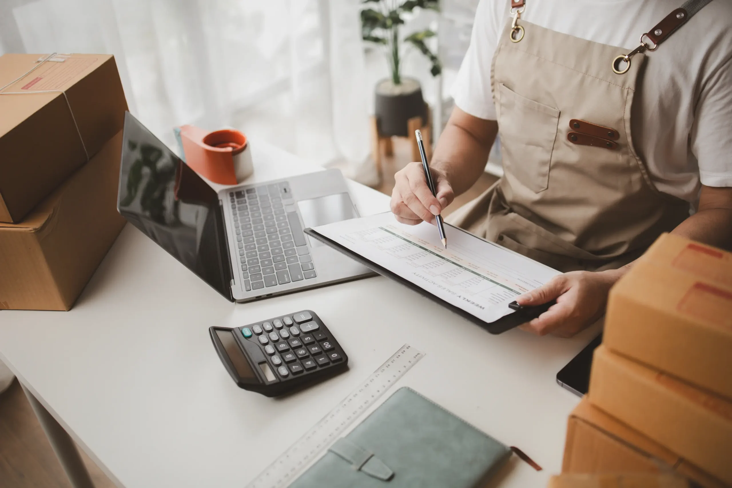 Small business owner preparing financial documents and inventory records to sell the company